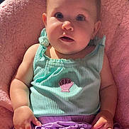 Willow is registered to the contest to win money with this photo: baby, child, chubby_cheeks, clothing, comfortable, curious_expression, cute, face, hand, indoors, infant, mint_green_top, pink_blanket, portrait, purple_clothing, seashell_patch, sitting, skin, soft_lighting, young
