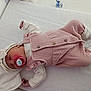 baby, newborn, sleeping, pacifier, pink_outfit, knitted_booties, hat, towel, infant, cute, peaceful, resting, clothing, soft_texture, indoor, child, portrait, lying_down, sleep, adorable
