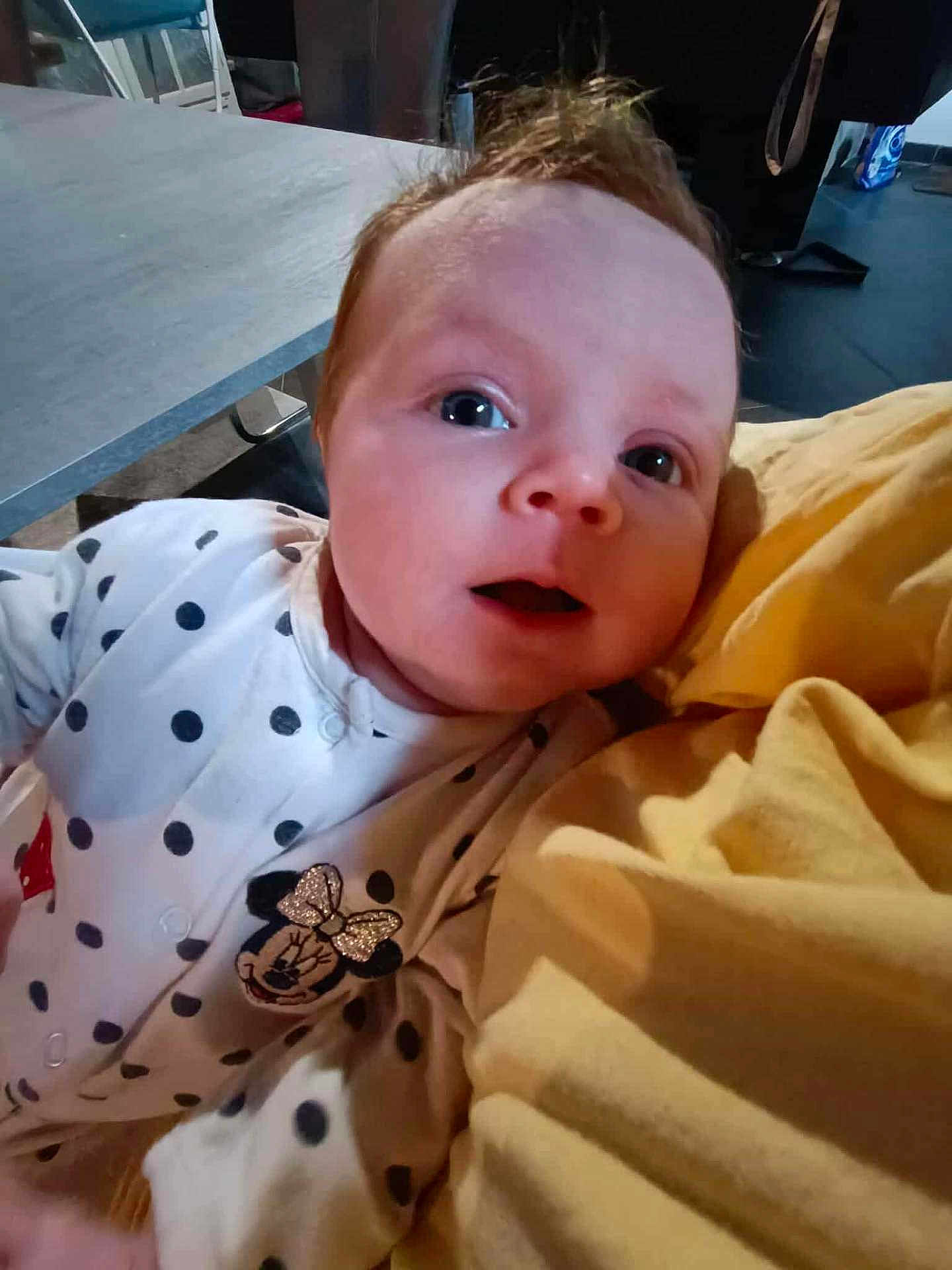 Naëlys participe au concours pour gagner de l'argent avec cette photo : baby, infant, polka_dot, white_clothing, minnie_mouse, yellow_blanket, face, eyes, expression, indoor, table, chair, person, cute, child, head, portrait, soft, young, curious
