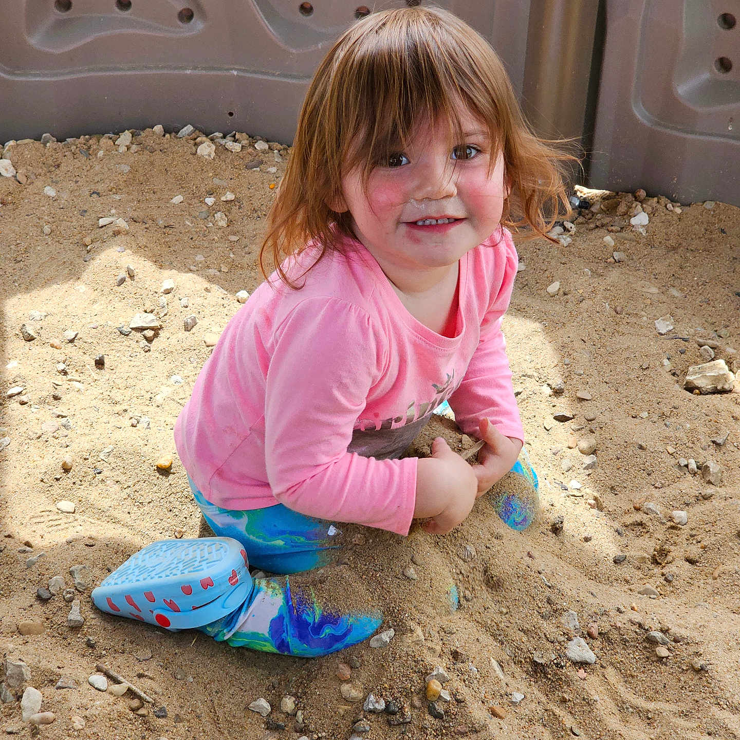 Adaline is registered to the contest to win money with this photo: child, clothing, face, female, footwear, girl, head, hottub, outdoors, pants, person, photography, portrait, rock, shoe, sitting, sneaker, soil, tub, wood