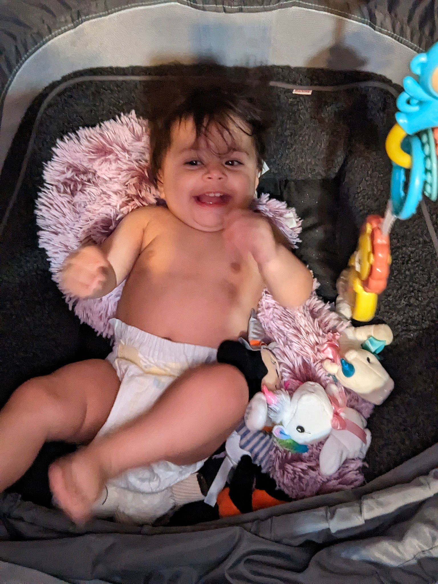 Sophie is registered to the contest to win money with this photo: baby_products, cheek, child, comfort, fun, happy, human_body, lap, people, person, pink, product, sitting, skin, smile, textile, thigh, toddler, toy, trunk