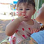 Paisley joined the competition — help win amazing prizes! arm, baby, blue_eyes, brick_wall, casual_clothing, child, closeup, curly_hair, cute, daylight, fingers_in_mouth, human, infant, outdoor, person_holding_child, pink_dress, portrait, skin, tattoo, tent