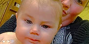 Paisley is registered to the contest to win money with this photo: baby, woman, indoor, selfie, pigtails, cabinet, yellow_wall, smile, person, holding, closeup, hair, face, clothing, eyewear, patterned_dress, toy, skin, child, portrait