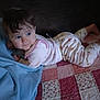Paisley joined the competition — help win amazing prizes! baby, bed, blanket, blue_blanket, child, clothing, cozy, curly_hair, cute, face, hair, indoor, infant, looking_away, lying_down, pajamas, patterned_quilt, quilt, resting, soft_lighting