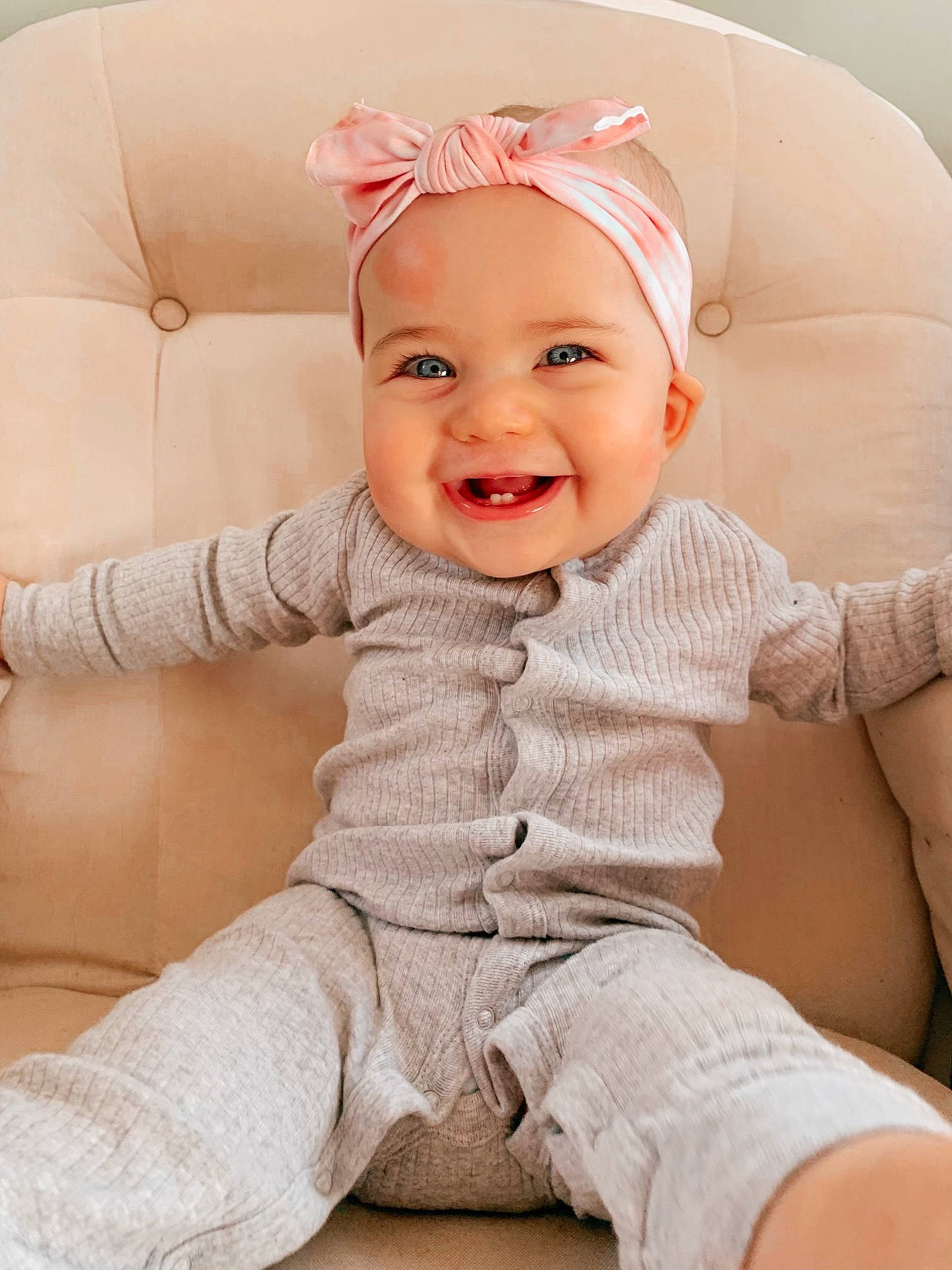 Rylee is registered to the contest to win money with this photo: baby, baby_toddler_clothing, chair, cheek, comfort, facial_expression, happy, headwear, human, human_body, joy, lip, mouth, neck, person, pink, skin, sleeve, smile, textile