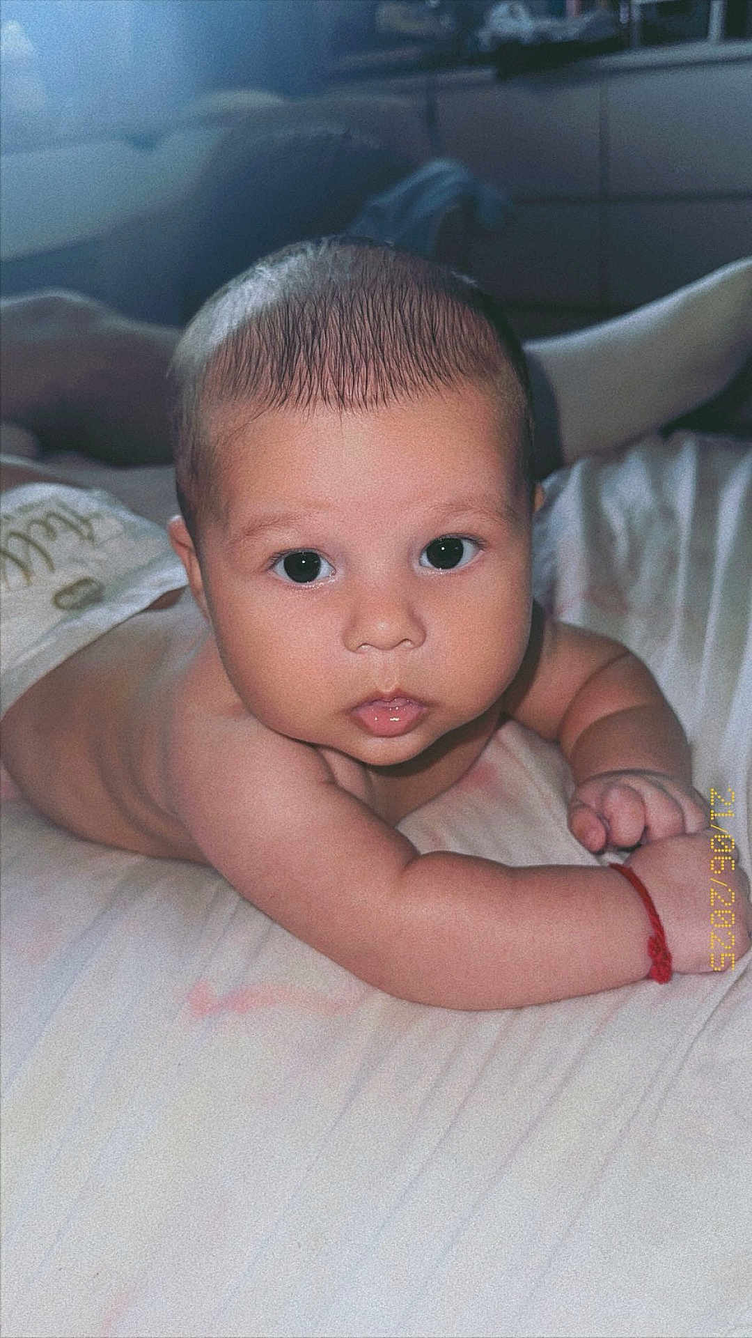 Alexander is registered to the contest to win money with this photo: baby, infant, child, tummy, skin, face, eyes, hand, fingers, bed, blanket, indoor, portrait, cute, looking, young, expression, soft_light, home, crawling