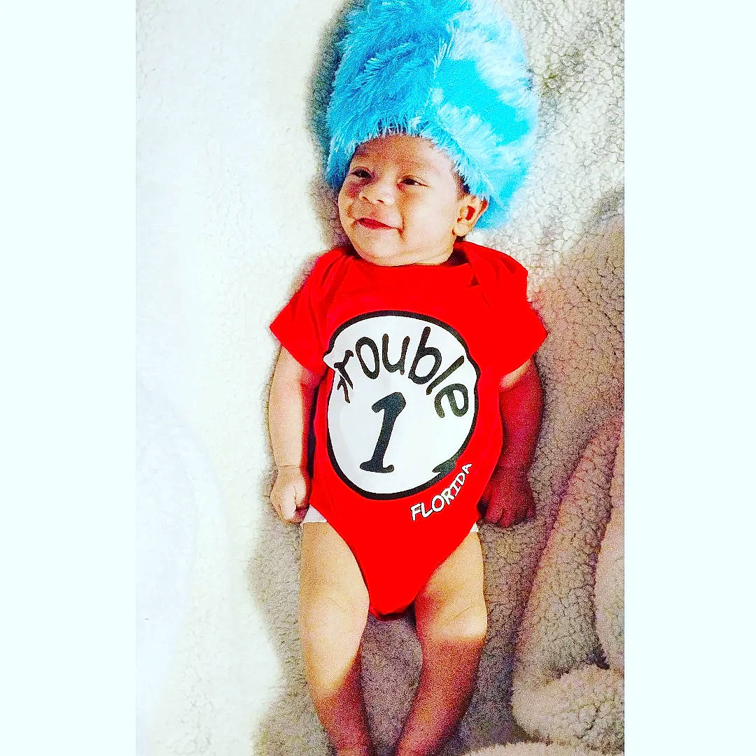 Darien joined the competition — help win amazing prizes! baby, baby_products, baby_toddler_clothing, cap, costume_hat, electric_blue, face, fictional_character, font, happy, head, jersey, neck, outerwear, pattern, person, sleeve, sportswear, t_shirt, thigh