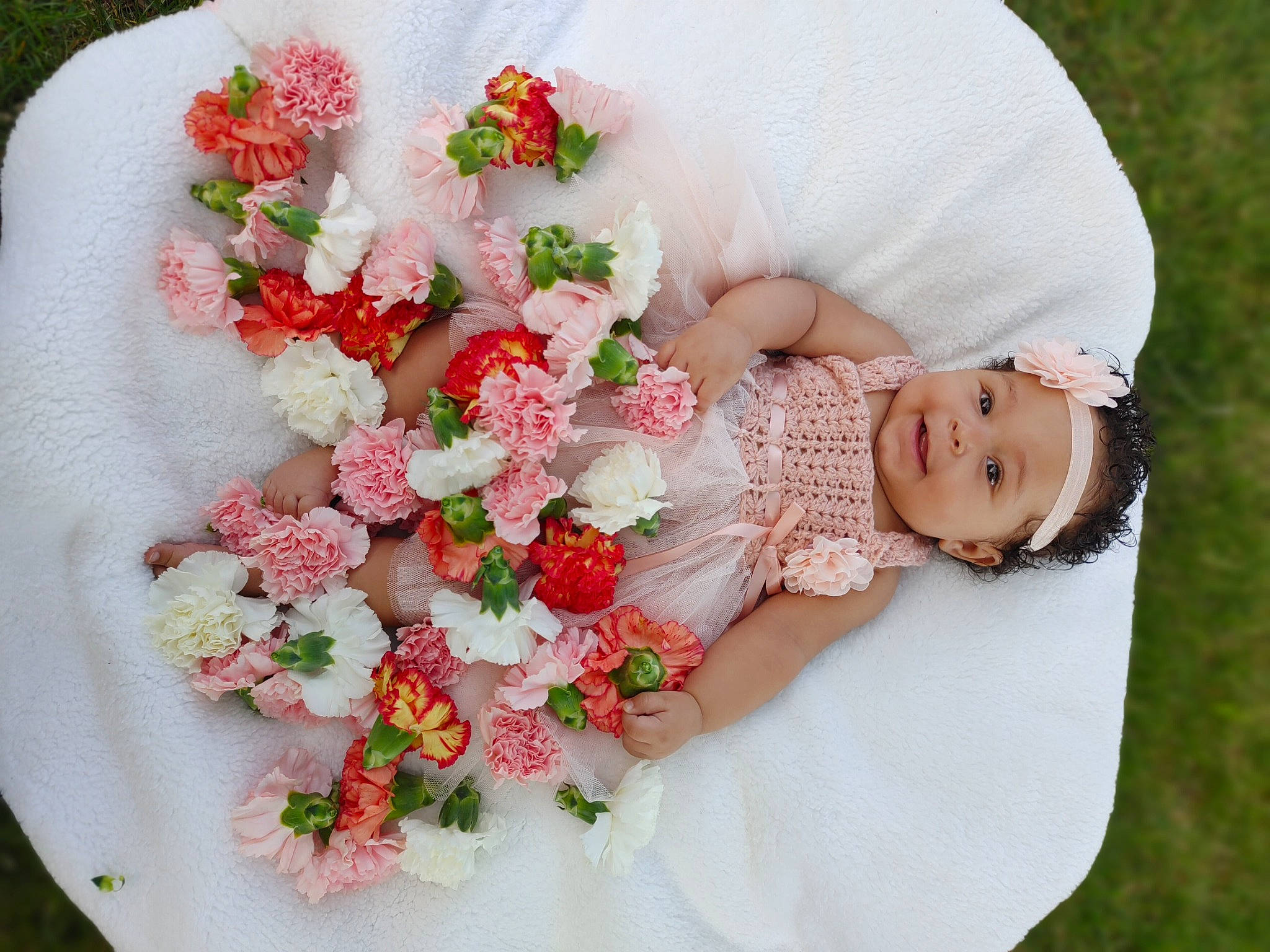 Gianna joined the competition — help win amazing prizes! baby, baby_toddler_clothing, botany, dress, finger, flower, flower_arranging, happy, headgear, human_body, hybrid_tea_rose, leg, person, petal, pink, plant, rose, skin, smile, textile