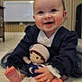 baby, smiling, indoor, plush_doll, child, happy, cute, soft_rug, clothing, toy, portrait, sitting, infant, face, feet, hands, warm, cozy, young_child, playful