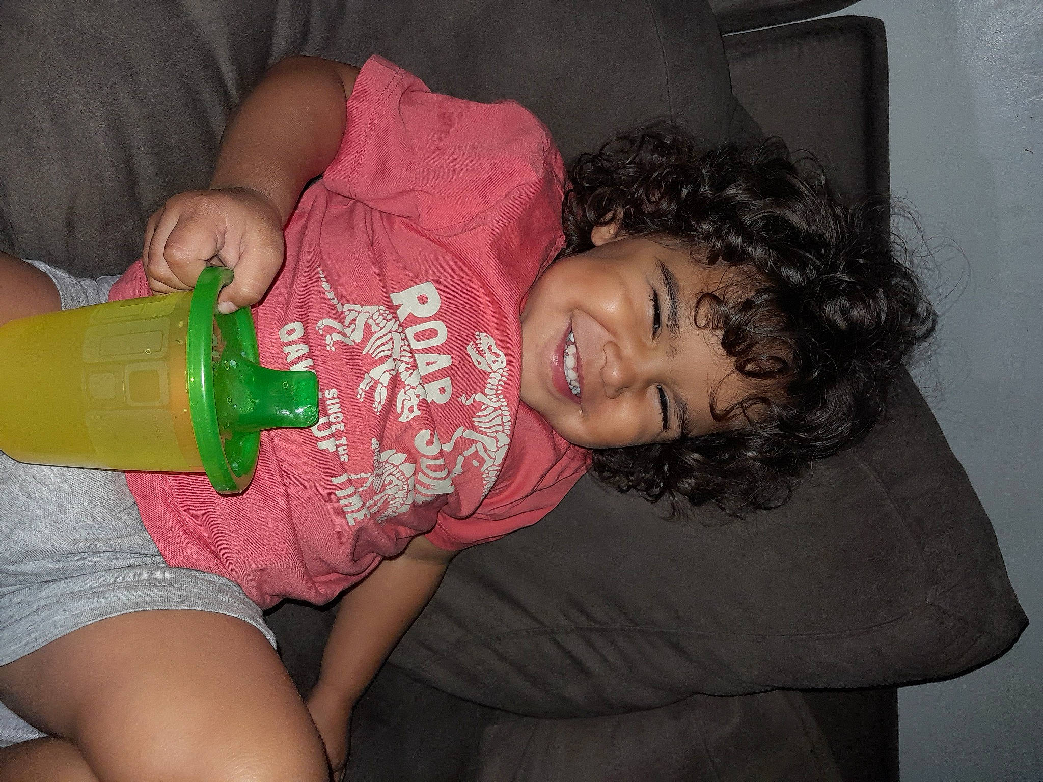 Atticus is registered to the contest to win money with this photo: baby_products, baby_toddler_clothing, chest, child, drink, drinking, drinkware, fun, happy, joy, juice, milk, mouth, nail, person, plastic_bottle, skin, tableware, thigh, toddler