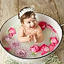 Félicia a rejoint le concours — aidez-le/la à gagner de superbes lots ! baby, baby_smiling, child, clapping, cute, flower_crown, flower_petals, flowers, happy, headband, indoors, infant, lavender_roses, milky_bath, pink_roses, portrait, splashing, water, white_basin, wooden_floor