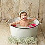 baby, bathtub, child, cute, decor, flower, flower_crown, happy, indoor, infant, milky_water, pink_roses, portrait, sitting, skin, smiling, water, white_flowers, white_tub, wooden_floor