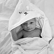 Brody is registered to the contest to win money with this photo: baby, infant, towel, blanket, hooded_towel, cute, wrapped, sleepy, soft, newborn, skin, face, expression, indoors, resting, comfort, portrait, child, cozy, monochrome