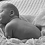 Brody is registered to the contest to win money with this photo: baby, sleeping, newborn, blanket, soft, texture, monochrome, black_and_white, peaceful, cute, infant, skin, portrait, rest, cozy, wrapped, small, face, hand, head
