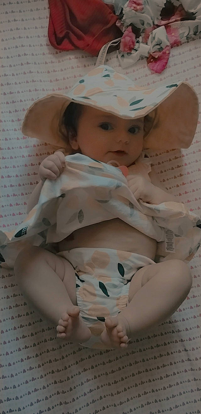 Dalilah joined the competition — help win amazing prizes! baby, baby_toddler_clothing, cheek, chin, dress, face, hat, head, headgear, headwear, human_body, iris, lip, neck, pattern, person, pink, skin, sleeve, sun_hat