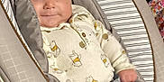 Jerrold joined the competition — help win amazing prizes! baby, baby_seat, child, clothing, comfort, cushion, denim_shorts, expression, face, footwear, hand, indoor, infant, legs, onesie, person, seat, smile, strap, young