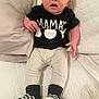 Grayson joined the competition — help win amazing prizes! baby, infant, child, person, shirt, clothing, pants, footwear, socks, couch, quilt, fabric, indoor, seated, expression, surprised, cute, portrait, human, black_shirt