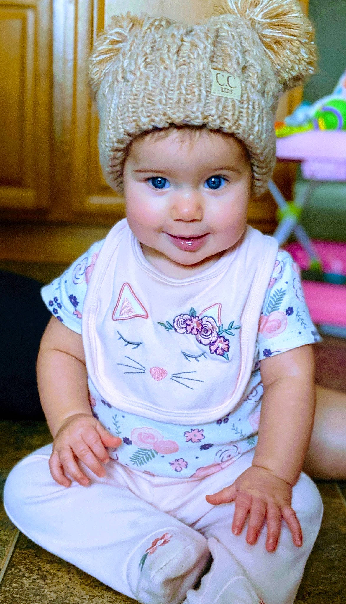 Kynslee is registered to the contest to win money with this photo: baby, baby_toddler_clothing, beanie, bonnet, cap, cheek, child, child_model, clothing, fashion_accessory, happy, hat, headgear, headwear, knit_cap, person, pink, sitting, skin, smile
