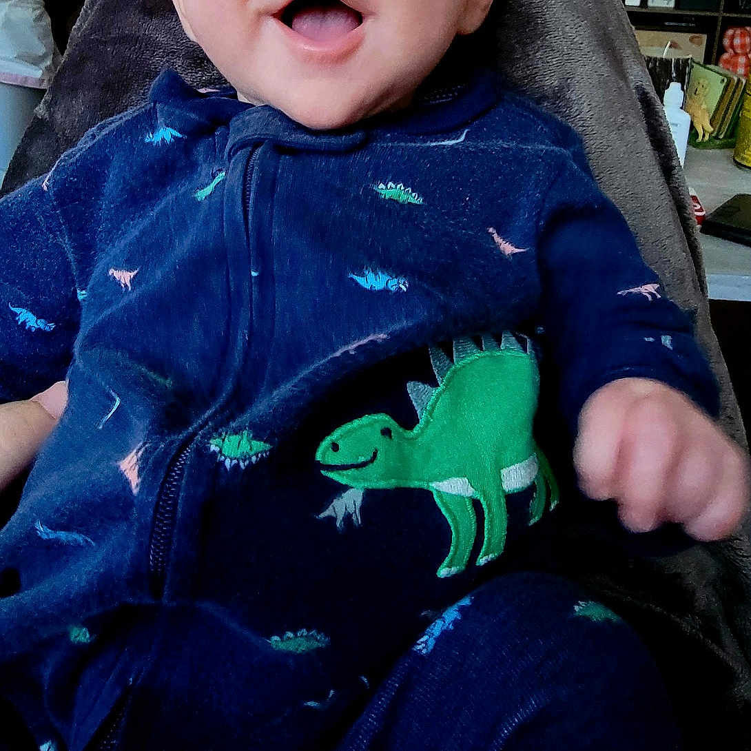Colter joined the competition — help win amazing prizes! adult, baby, blanket, clothing, coat, face, furniture, happy, head, jacket, jeans, laughing, male, man, pajamas, pants, person, photography, portrait, smile