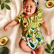 Cleiah Bright is registered to the contest to win money with this photo: baby, infant, child, smiling, avocado, fruit, green_leaves, blanket, clothing, headband, cute, lying_down, happy, portrait, toddler, nature, fresh, soft_texture, playful, outdoor_style