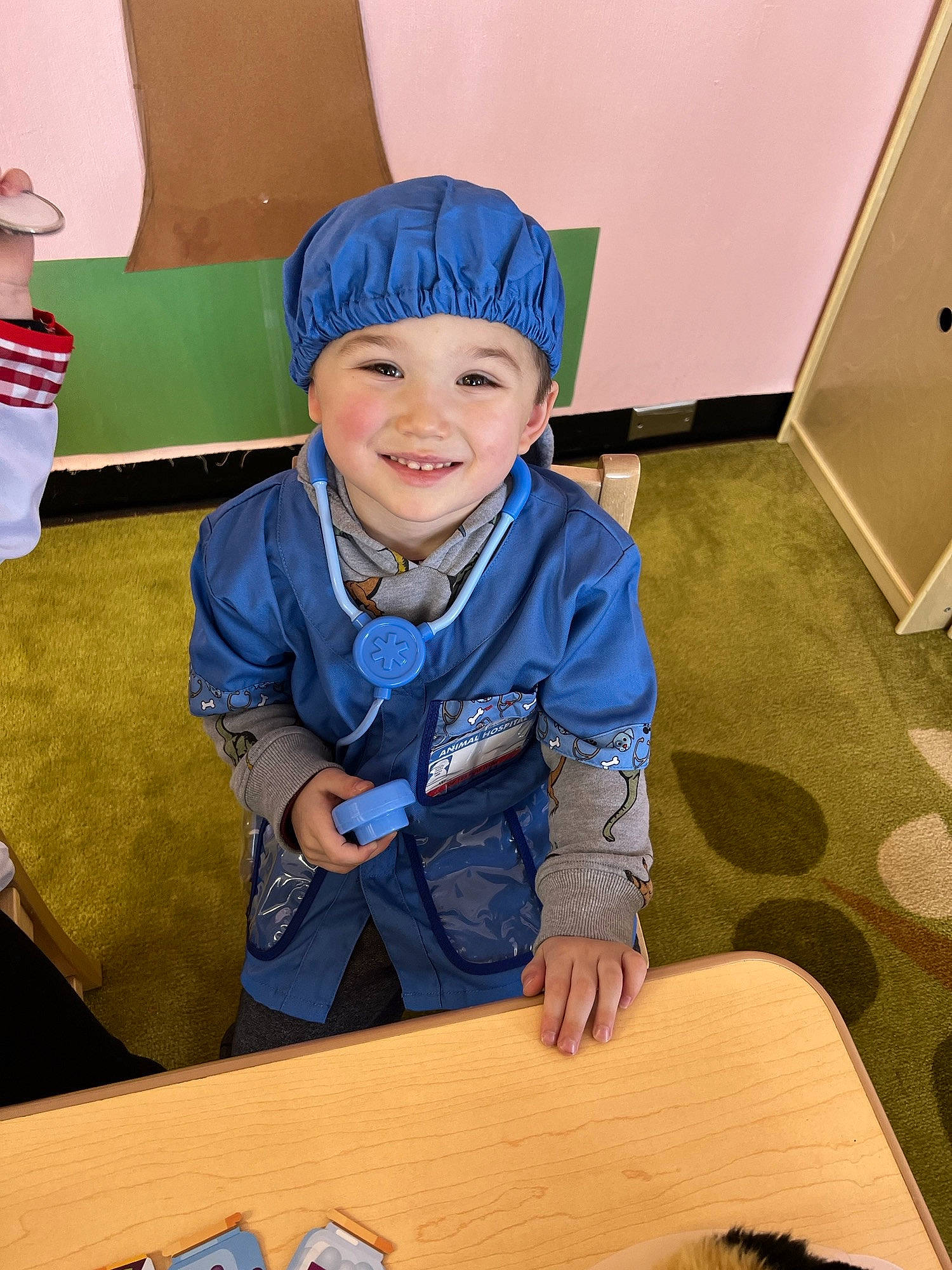 Kaejay joined the competition — help win amazing prizes! cap, chair, child, electric_blue, eye, fashion_accessory, flooring, fun, happy, hat, headgear, headwear, joy, kindergarten, person, personal_protective_equipment, play, room, sitting, smile