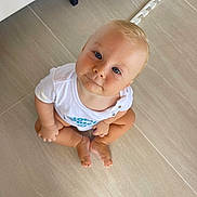 Mieszko joined the competition — help win amazing prizes! baby, barefoot, blue_eyes, child, curious, cute, face, floor, head, indoor, looking_up, minimalist, person, portrait, sitting, skin, tile_floor, toddler, white_shirt, young_child