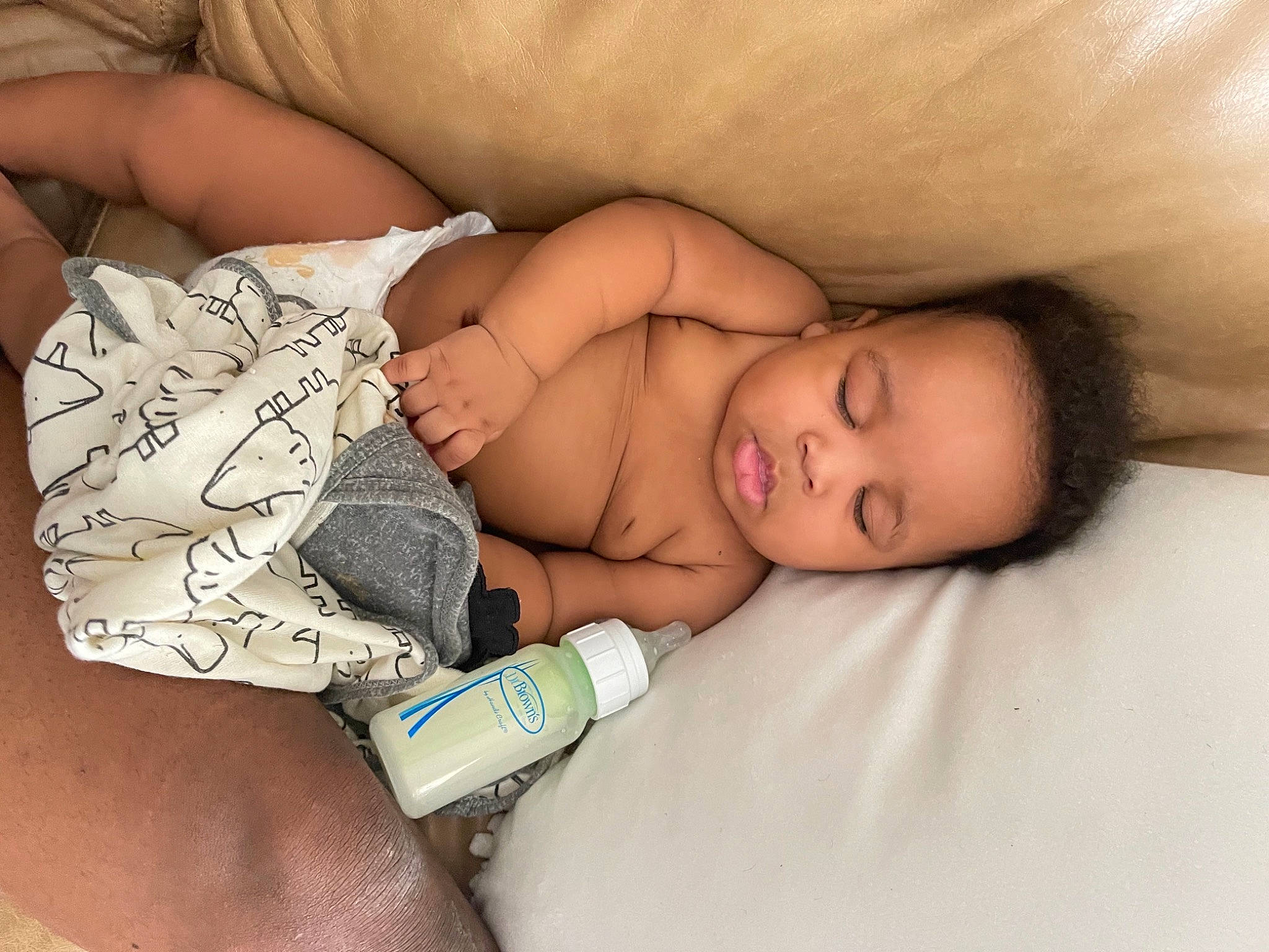 Bryson is registered to the contest to win money with this photo: arm, baby, baby_sleeping, child, comfort, elbow, finger, gesture, human_body, human_leg, joint, mammal, mouth, muscle, nail, person, skin, textile, thigh, toddler