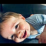 Greyson is registered to the contest to win money with this photo: baby, child, smiling, face, close_up, blue_shirt, happy, infant, skin, eyes, hair, portrait, lying_down, cute, expression, young_child, indoors, soft_light, head, person