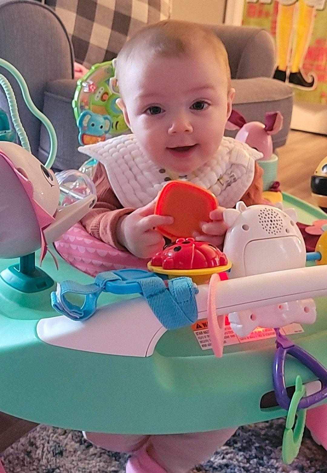 Sadie joined the competition — help win amazing prizes! baby, baby_playing_with_toys, baby_products, baby_toddler_clothing, baby_toys, chair, child, comfort, fun, happy, lap, leisure, person, pink, play, room, sitting, smile, stuffed_toy, toddler