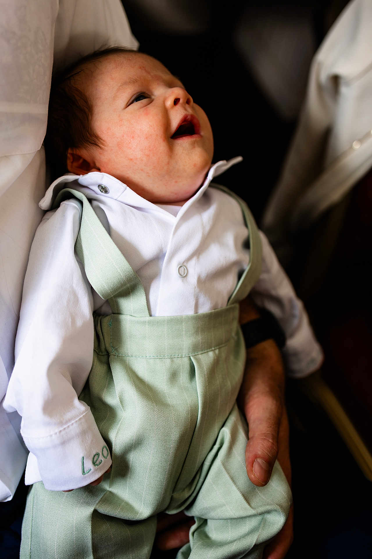 Leo joined the competition — help win amazing prizes! baby, infant, child, white_shirt, green_suspender, portrait, smiling, happy, cute, person, human_hand, closeup, fashion, clothing, young_child, indoor, soft_lighting, gentle, care, love