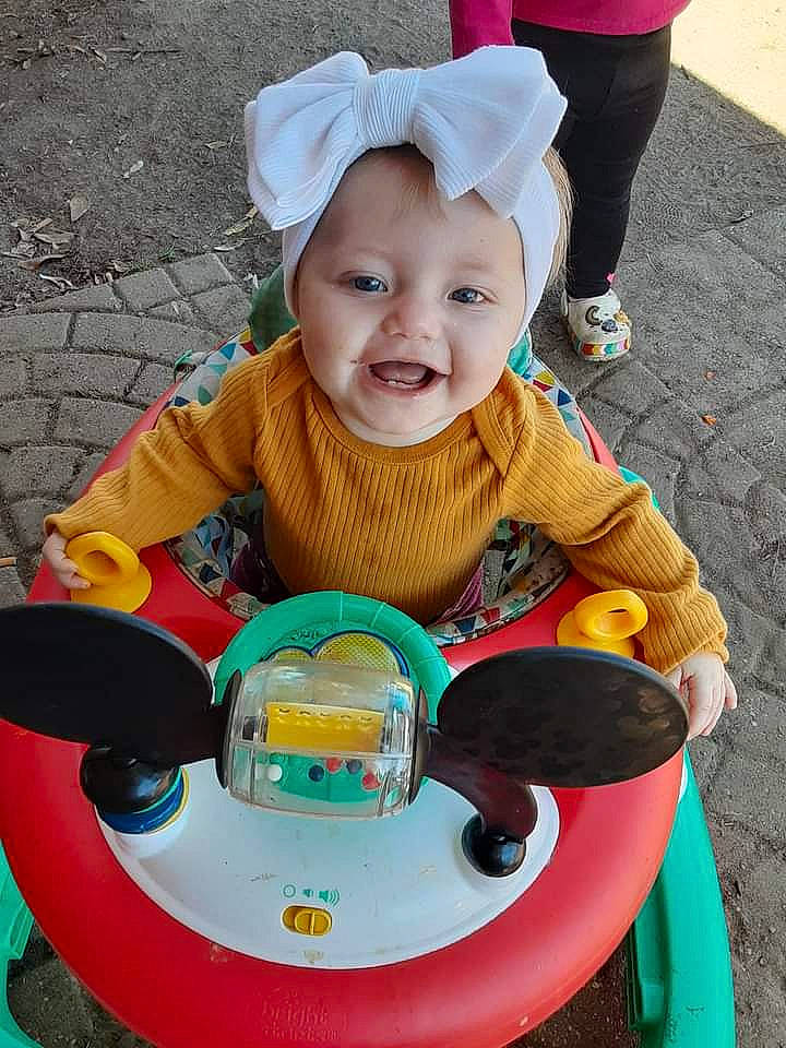 Haisley is registered to the contest to win money with this photo: baby, baby_playing_with_toys, baby_toddler_clothing, child, event, fun, grass, happy, hat, headwear, leisure, people, person, photograph, play, recreation, riding_toy, sitting, smile, snapshot
