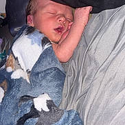 Bradyn is registered to the contest to win money with this photo: newborn, baby, sleeping, blanket, blue_blanket, animal_print, cozy, soft_texture, infant, peaceful, resting, wrapped, face, hand, skin, indoors, fabric, gray, closeup, portrait