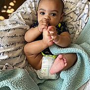 Ashure Matthews is registered to the contest to win money with this photo: baby, infant, foot, hand, blanket, diaper, cute, face, eyes, soft, cozy, indoor, child, person, toddler, skin, comfort, wearing, holding, cuddly