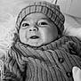 Owen participe au concours pour gagner de l'argent avec cette photo : baby, infant, face, hat, knitwear, striped_clothing, black_and_white, portrait, closeup, cute, child, expression, fluffy, soft_texture, buttoned_clothing, warm_clothing, indoors, smile, person, newborn