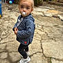 Lyana a rejoint le concours — aidez-le/la à gagner de superbes lots ! toddler, child, pacifier, hoodie, blue, speckled, outdoor, pavement, stone, cracked, curious, expression, casual_clothing, white_shoes, young_child, person, standing, garden, blurred_background, daylight