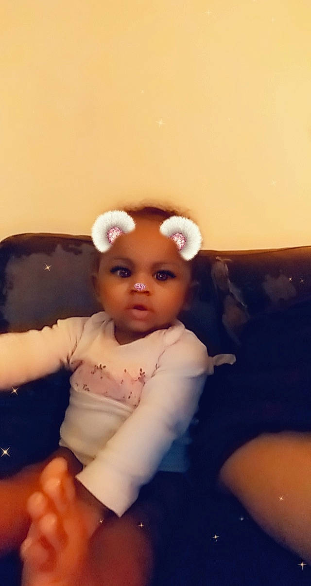 Lorraine is registered to the contest to win money with this photo: baby, cheek, child, ear, eye, forehead, fun, hair_accessory, head, nose, person, sitting, skin, smile, toddler