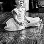 toddler, child, smiling, sitting, tutu, dress, floor, wooden_floor, black_and_white, happy, indoors, home, girl, cute, portrait, person, young_child, clothing, playful, decor