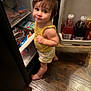 toddler, child, yellow_clothing, fridge, open_fridge, floor, wooden_floor, indoor, food, beverages, curious, barefoot, smiling, looking_up, hair_bow, shorts, kitchen, grocery, snack, domestic