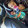 Piper is registered to the contest to win money with this photo: toddler, child, car_seat, pacifier, toy, car_interior, seatbelt, leather_seat, baby, infant, vehicle, child_safety, window, curious, young_child, strapped_in, car_ride, baby_toy, child_in_car, baby_holding_toy