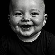 Diego participe au concours pour gagner de l'argent avec cette photo : baby, child, smiling, black_and_white, portrait, water_droplets, face, happy, cute, eyes, skin, closeup, head, infant, expression, clothing, black_shirt, chubby_cheeks, studio, background