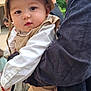 Diego a rejoint le concours — aidez-le/la à gagner de superbes lots ! baby, child, man, hat, outdoor, people, clothing, corduroy, beige, white_shirt, holding, portrait, face, person, footwear, bag, greenery, building, expression, closeup