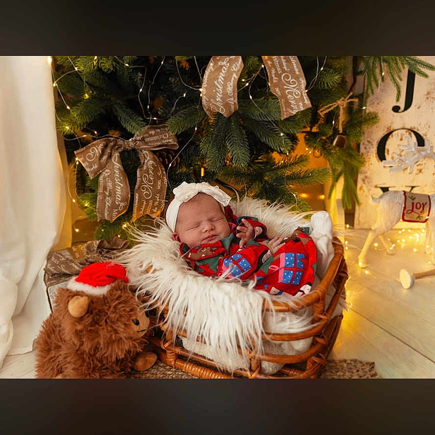 Gracelyn joined the competition — help win amazing prizes! baby, basket, christmas, cozy, cute, decorations, festive, floor, fluffy, headband, holiday, indoors, lights, pajamas, ribbons, santa_hat, sleeping, teddy_bear, tree, wooden
