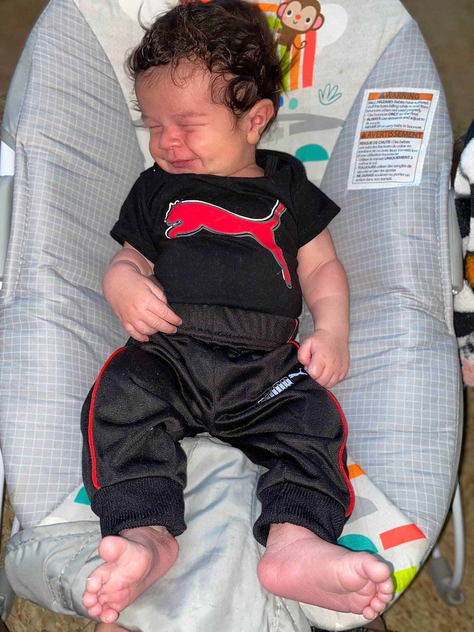 Camden is registered to the contest to win money with this photo: baby, baby_products, baby_toddler_clothing, carmine, chair, child, comfort, elbow, foot, human_leg, knee, lap, leg, pattern, person, sitting, sleeve, sock, t_shirt, thigh