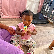 Reasin is registered to the contest to win money with this photo: baby, carpet, child, clothing, crib, curtain, cute, expression, floor, foot, hand, home, indoor, pajamas, person, sitting, stuffed_animal, toddler, toy, wooden_floor