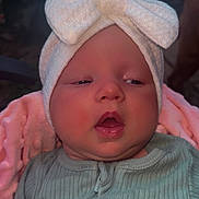 Adalynn joined the competition — help win amazing prizes! baby, child, infant, hat, bow, blanket, pink_blanket, green_outfit, ribbed_clothing, face, portrait, closeup, sleepy, soft_lighting, outdoor, nature_background, person, headwear, newborn, cute