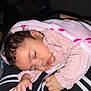 Aylani is registered to the contest to win money with this photo: baby, sleeping, blanket, pink, floral_pattern, child, person, lap, clothing, hand, face, curly_hair, cozy, indoor, rest, peaceful, soft_texture, warm, cute, toddler