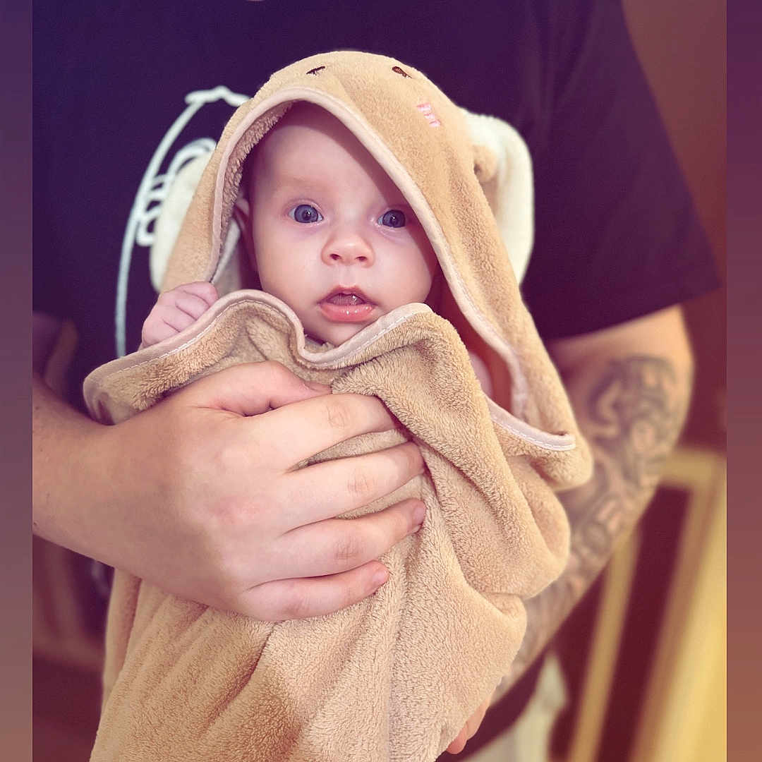 Phoebe-Ann joined the competition — help win amazing prizes! baby, blanket, bodypart, bonnet, clothing, face, finger, hand, happy, hat, head, hood, knitwear, newborn, person, photography, portrait, smile, sweater, towel