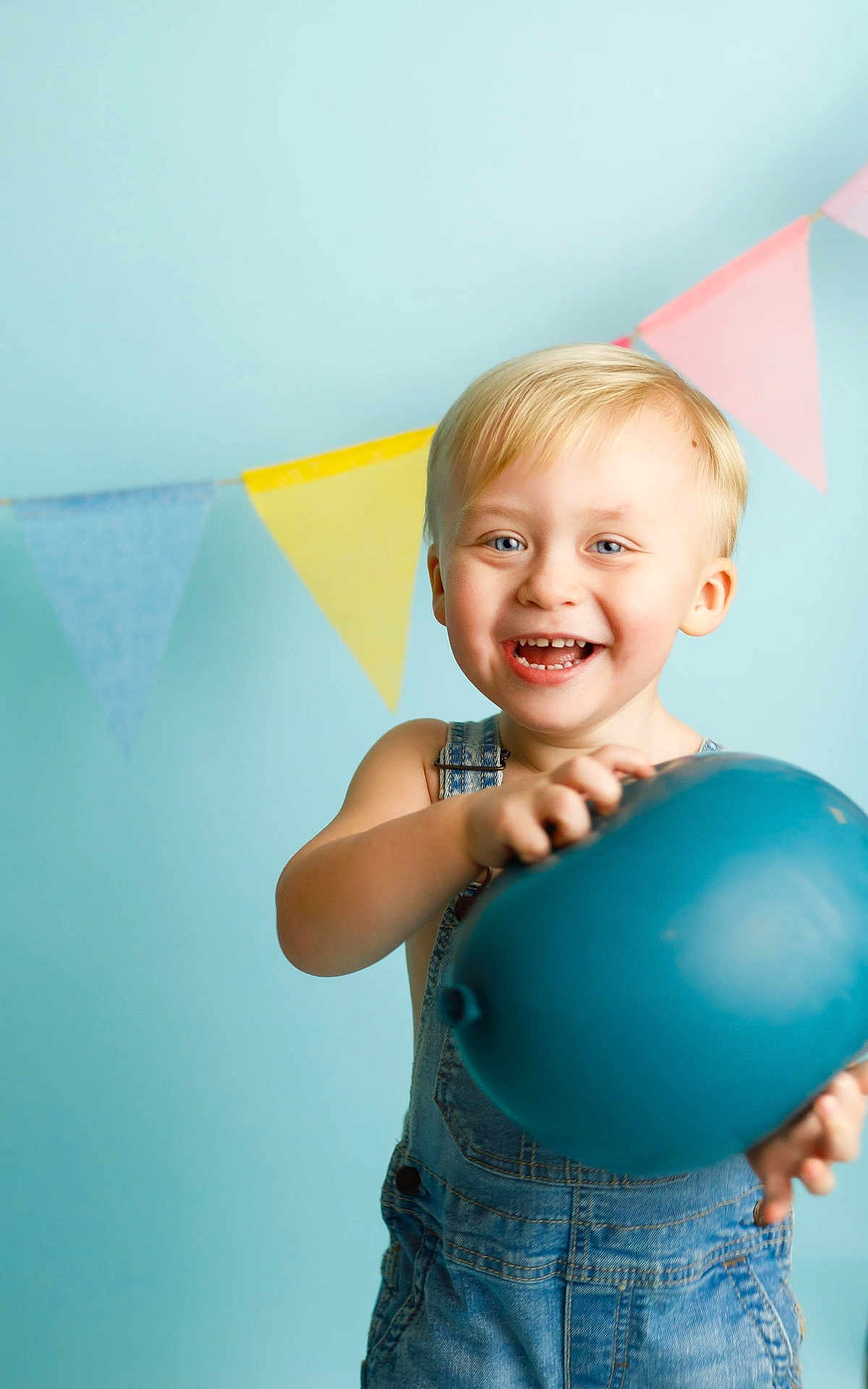 Walker is registered to the contest to win money with this photo: baby, balloon, blonde, bodypart, clothing, face, finger, hand, happy, head, jeans, laughing, mouth, pants, person, photography, portrait, smile, sphere, teeth
