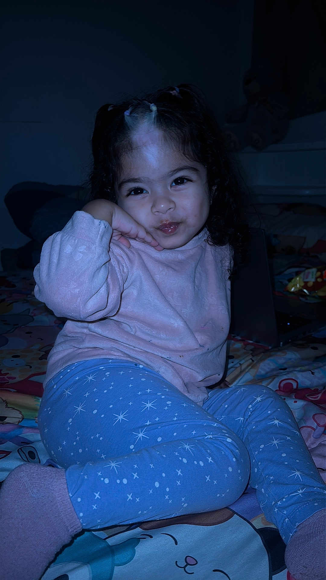 Júlia Saiume joined the competition — help win amazing prizes! child, girl, pajamas, socks, bed, bedspread, toy, laptop, indoor, dark, portrait, cute, playful, smiling, hand_on_cheek, curly_hair, cozy, room, nighttime, person