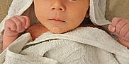 Nathanaël participe au concours pour gagner de l'argent avec cette photo : baby, towel, hooded_towel, white_towel, infant, cute, wide_eyes, skin, face, hands, raised_fists, soft_texture, beige_background, wrapped, newborn, portrait, indoor, child, expression, blanket